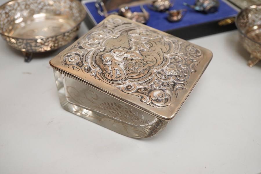 Small silver including a pair of George V pierced silver bonbon dishes, Birmingham, 1915, diameter 97mm, an Edwardian silver mounted glass inkwell, a cased modern silver miniature four piece tea set and tray and a German